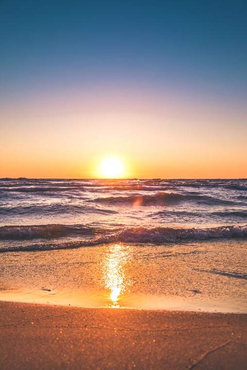 Sun low over the ocean at the beach