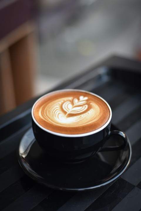 A latte with foam art on a cafe table